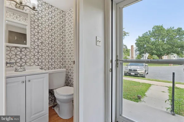 a bathroom with a toilet sink and mirror