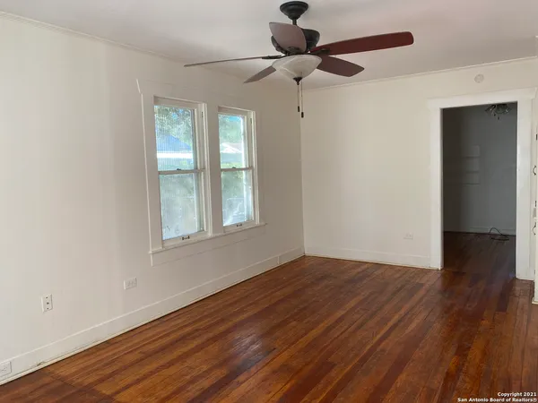 wooden floor in an empty room with a window