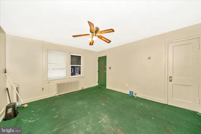 a view of a room with window and a ceiling fan