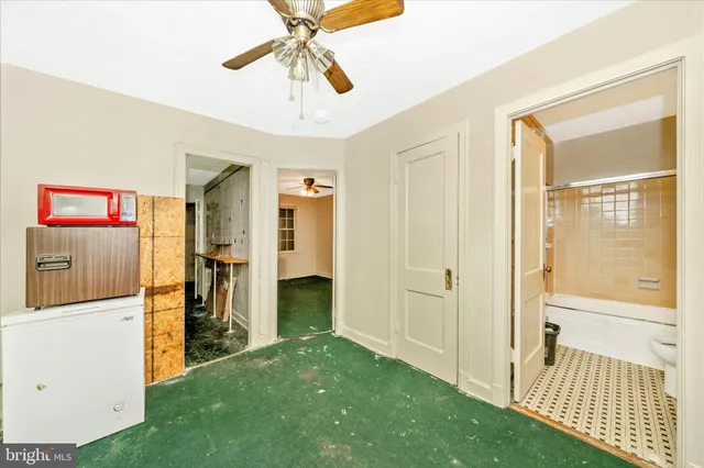 a view of an empty room with closet and wooden floor