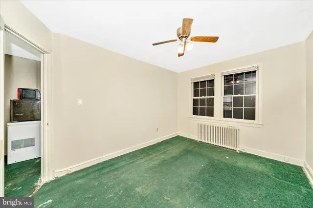 a view of a livingroom with a ceiling fan and window