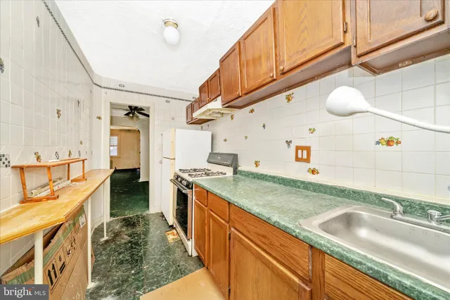 a kitchen with stainless steel appliances granite countertop a sink and stove