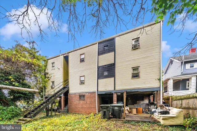 a backyard of a house with large trees