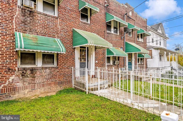 a view of a house with a yard and sitting area