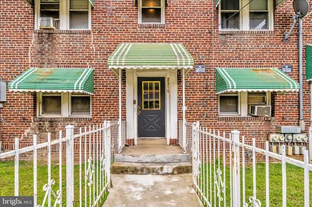 a view of a brick house with a small window