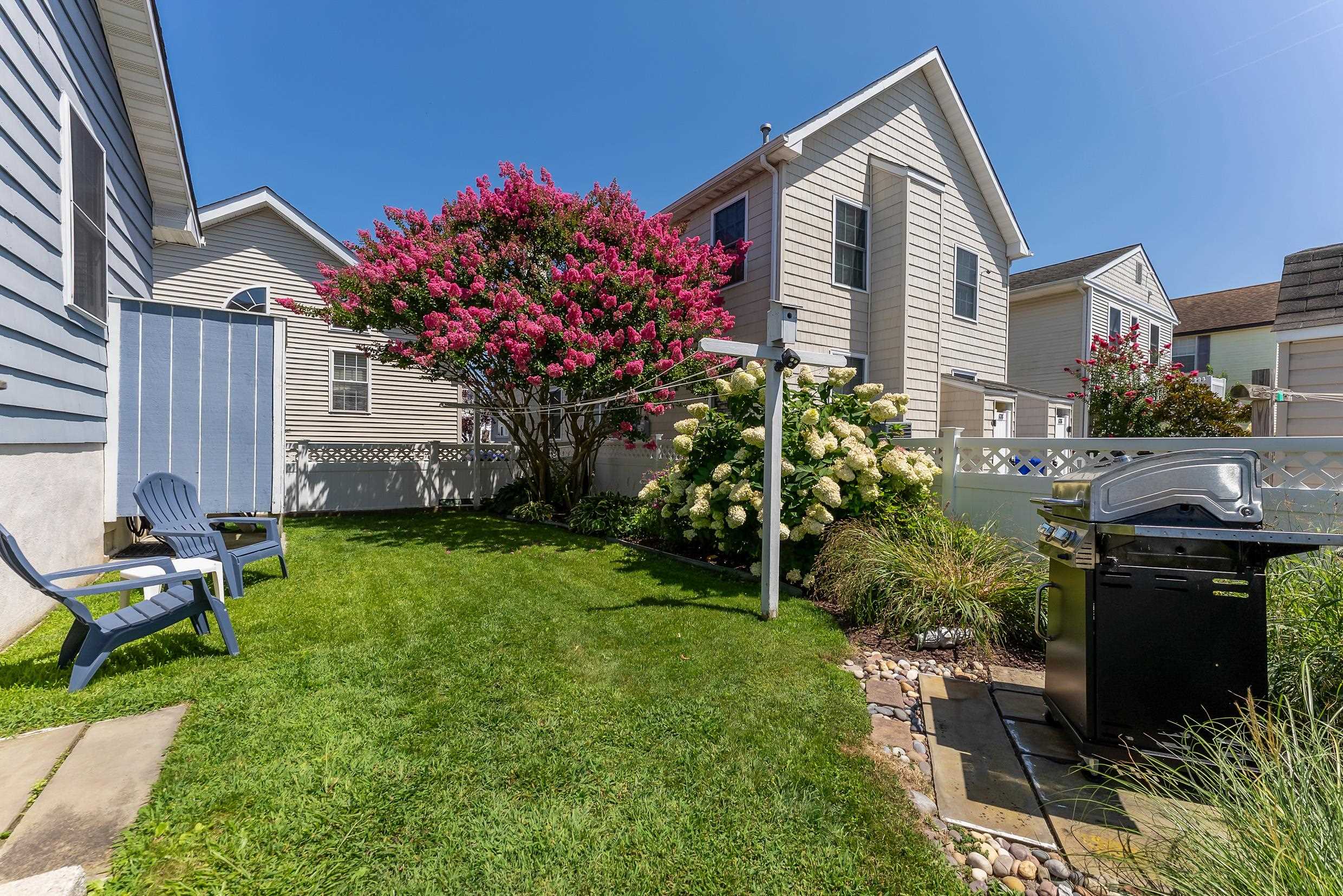 647 Barry Road Avalon, NJ 08202 - Photo 23 of 25 a front view of a house with a garden