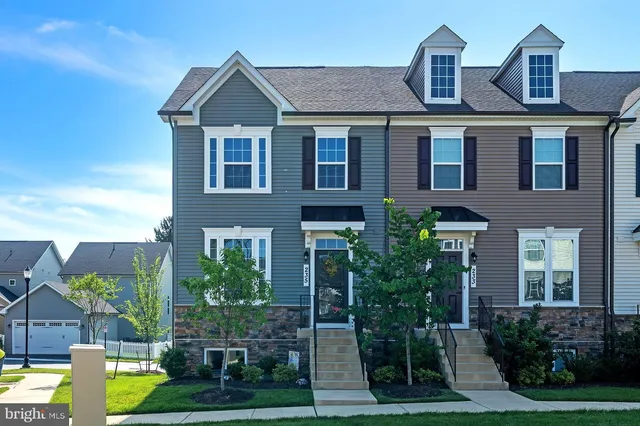 a front view of house with yard and green space