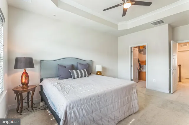 a bedroom with a bed and a lamp