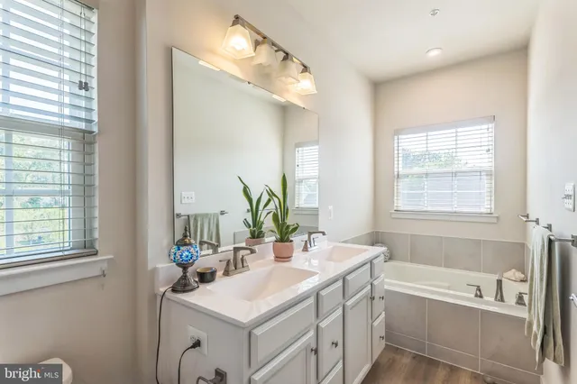 a bathroom with a double vanity sink mirror double and shower