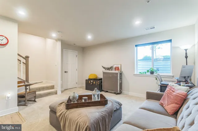 a bathroom with a sink mirror and a toilet