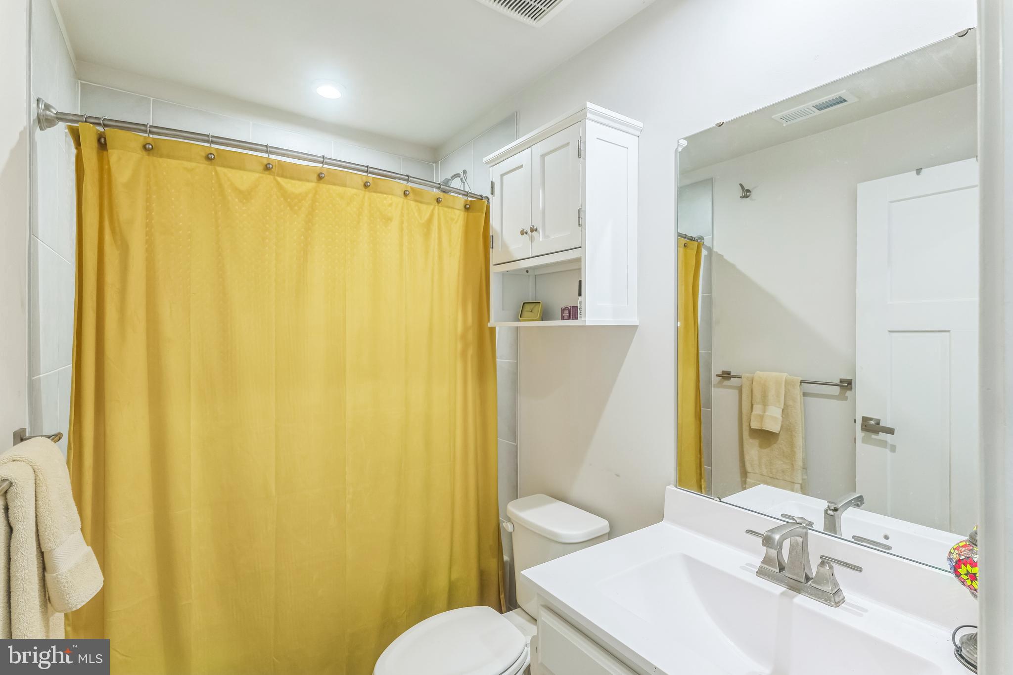 235 Edwin Road Frederick, MD 21702 - Photo 27 of 28 a bathroom with a sink mirror and a toilet