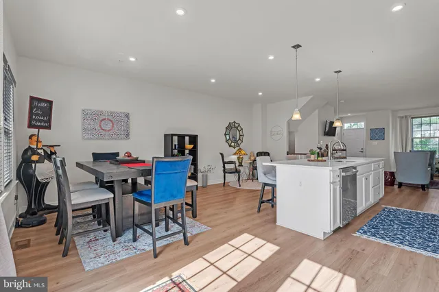 a living room with furniture a dining table and kitchen view