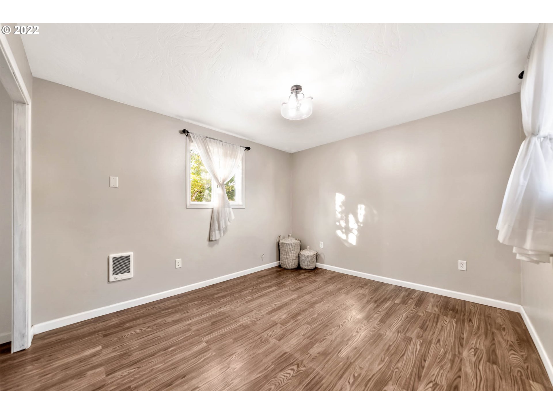 1849 H Street Springfield, OR 97477 - Photo 9 of 17 a view of an empty room with window and wooden floor