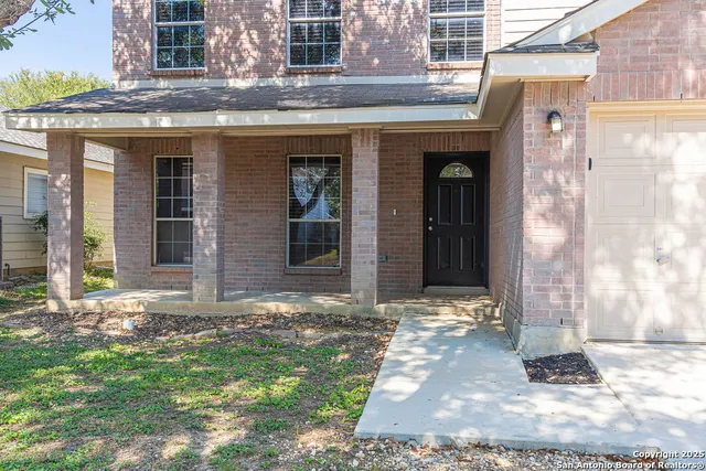 a view of a brick house with many windows