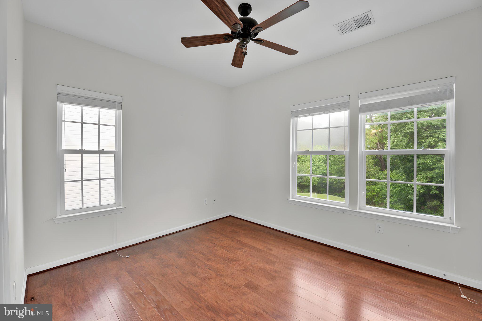7138 Station House Road Elkridge, MD 21075 - Photo 7 of 42 an empty room with wooden floor and windows