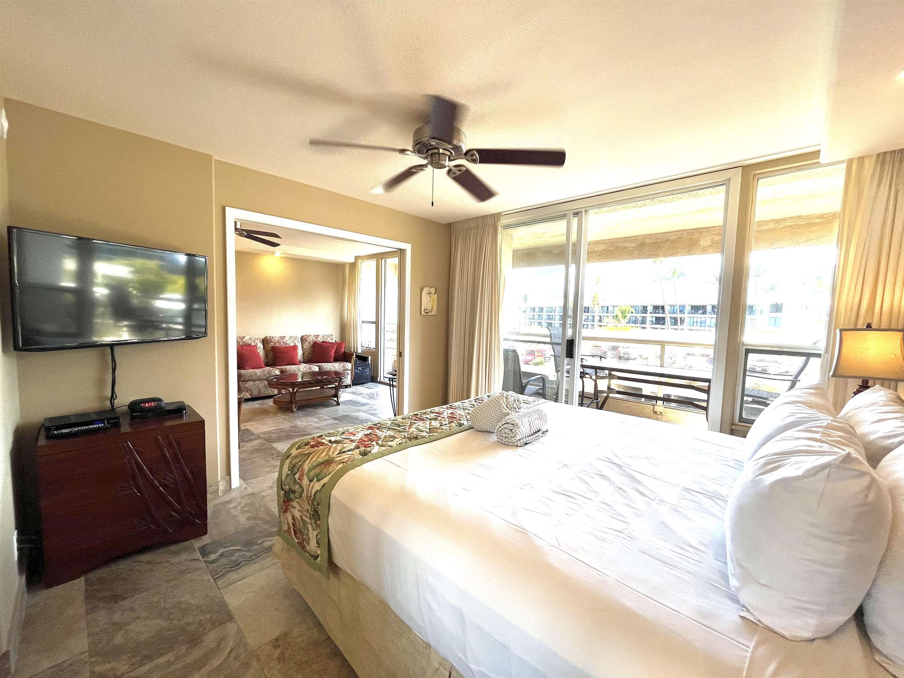 2575 South Kihei Road, Unit H414 Kihei, HI 96753 - Photo 12 of 30 a bedroom with a bed and glass windows