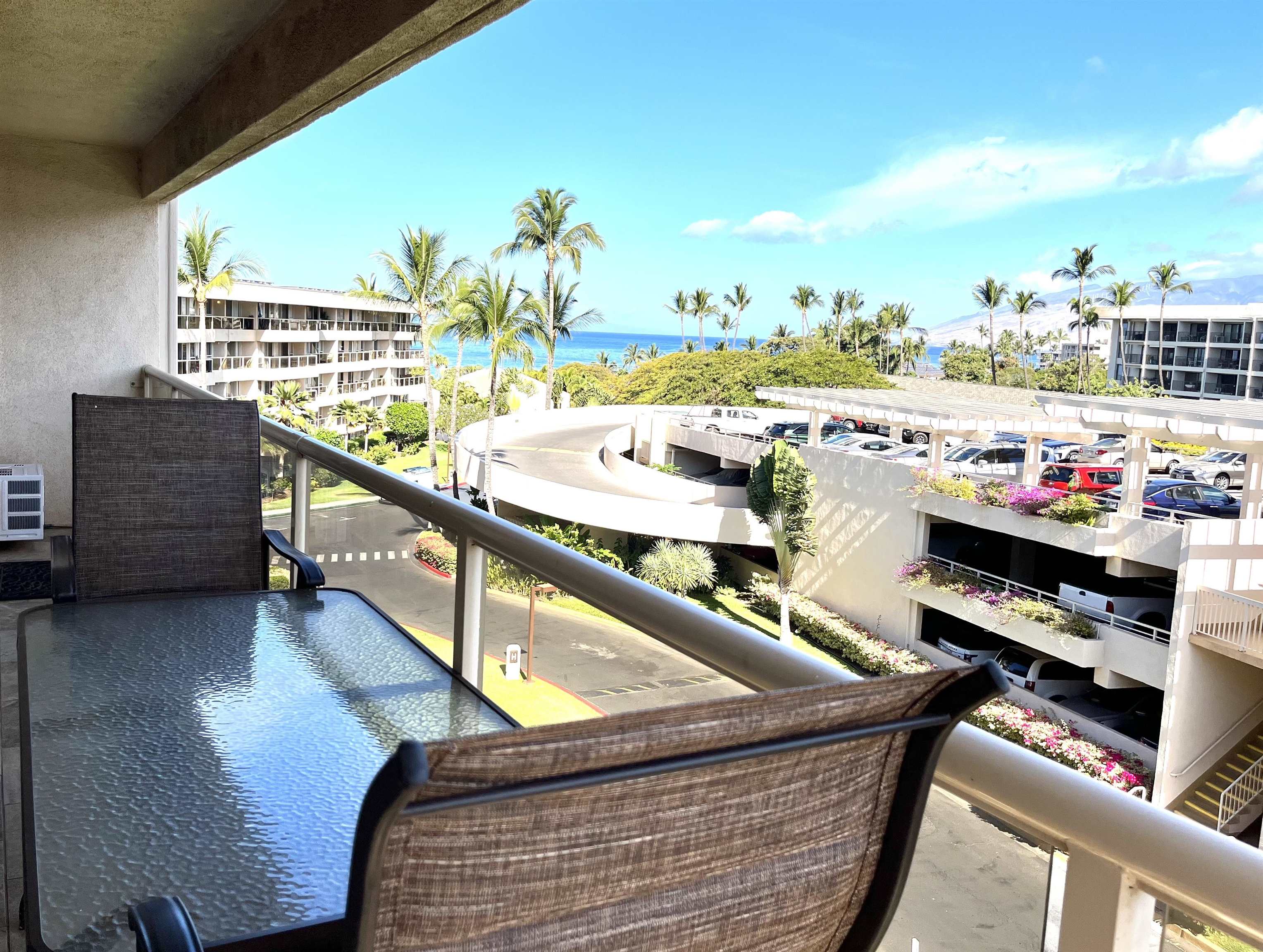2575 South Kihei Road, Unit H414 Kihei, HI 96753 - Photo 19 of 30 a balcony with wooden floor and outdoor seating