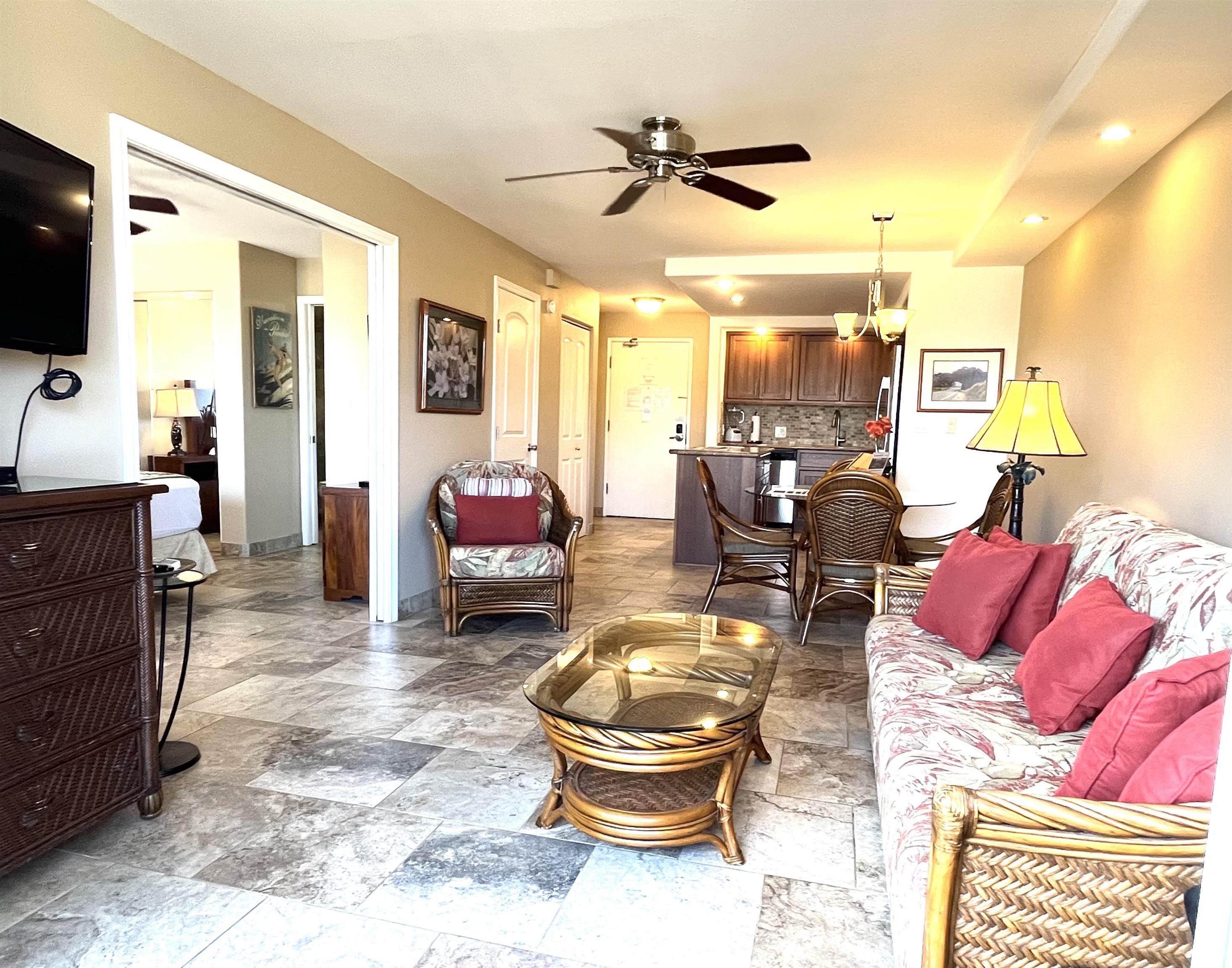 2575 South Kihei Road, Unit H414 Kihei, HI 96753 - Photo 2 of 30 a living room with furniture and a flat screen tv