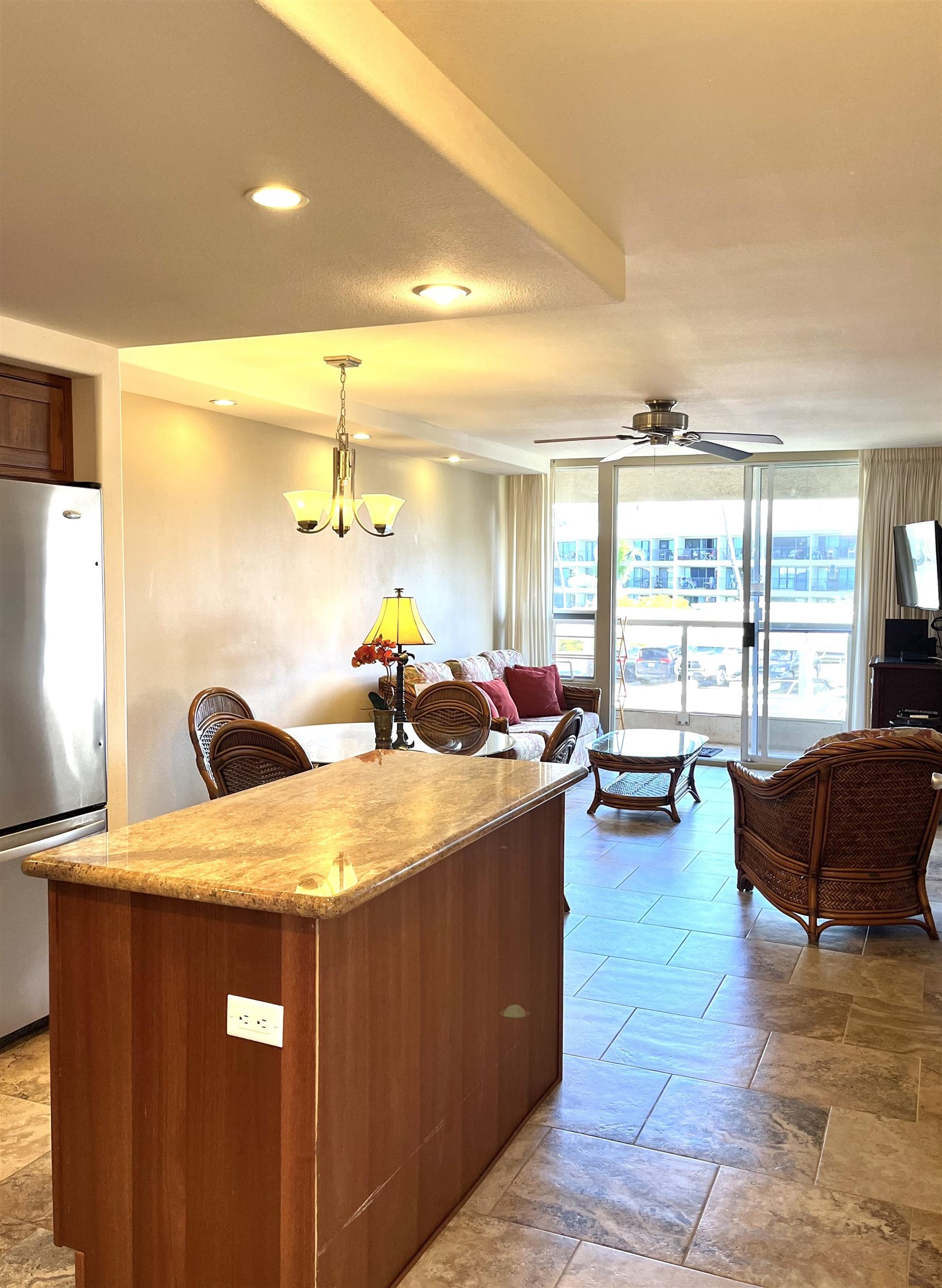 2575 South Kihei Road, Unit H414 Kihei, HI 96753 - Photo 7 of 30 a living room with furniture and a large window