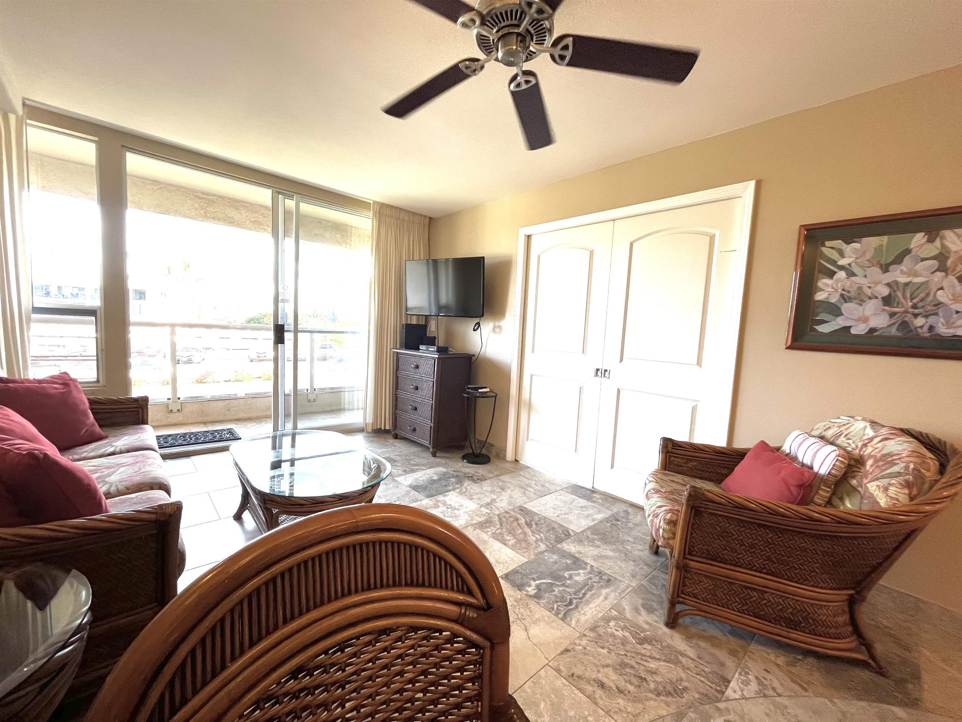 2575 South Kihei Road, Unit H414 Kihei, HI 96753 - Photo 9 of 30 a living room with furniture fireplace and a large window