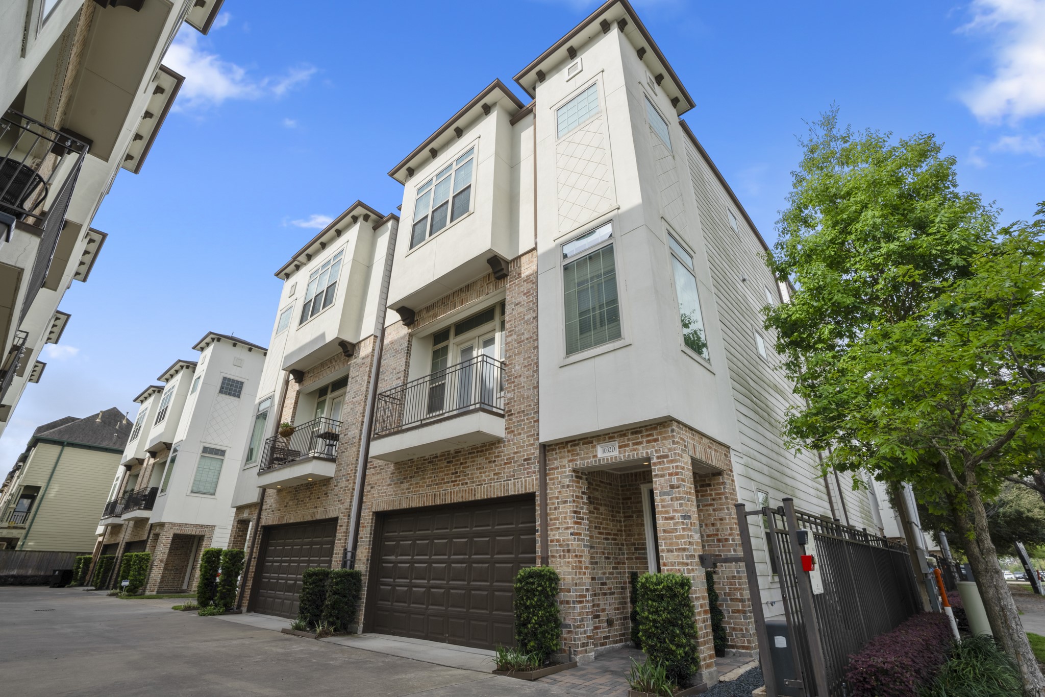1032 West 26th Street, Unit D Houston, TX 77008 - Photo 1 of 42 a front view of a building with lot of trees
