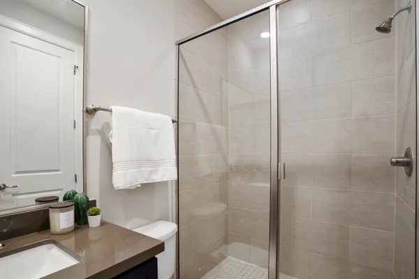 a bathroom with a shower and a sink