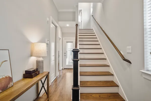 a view of entryway and hall with wooden floor