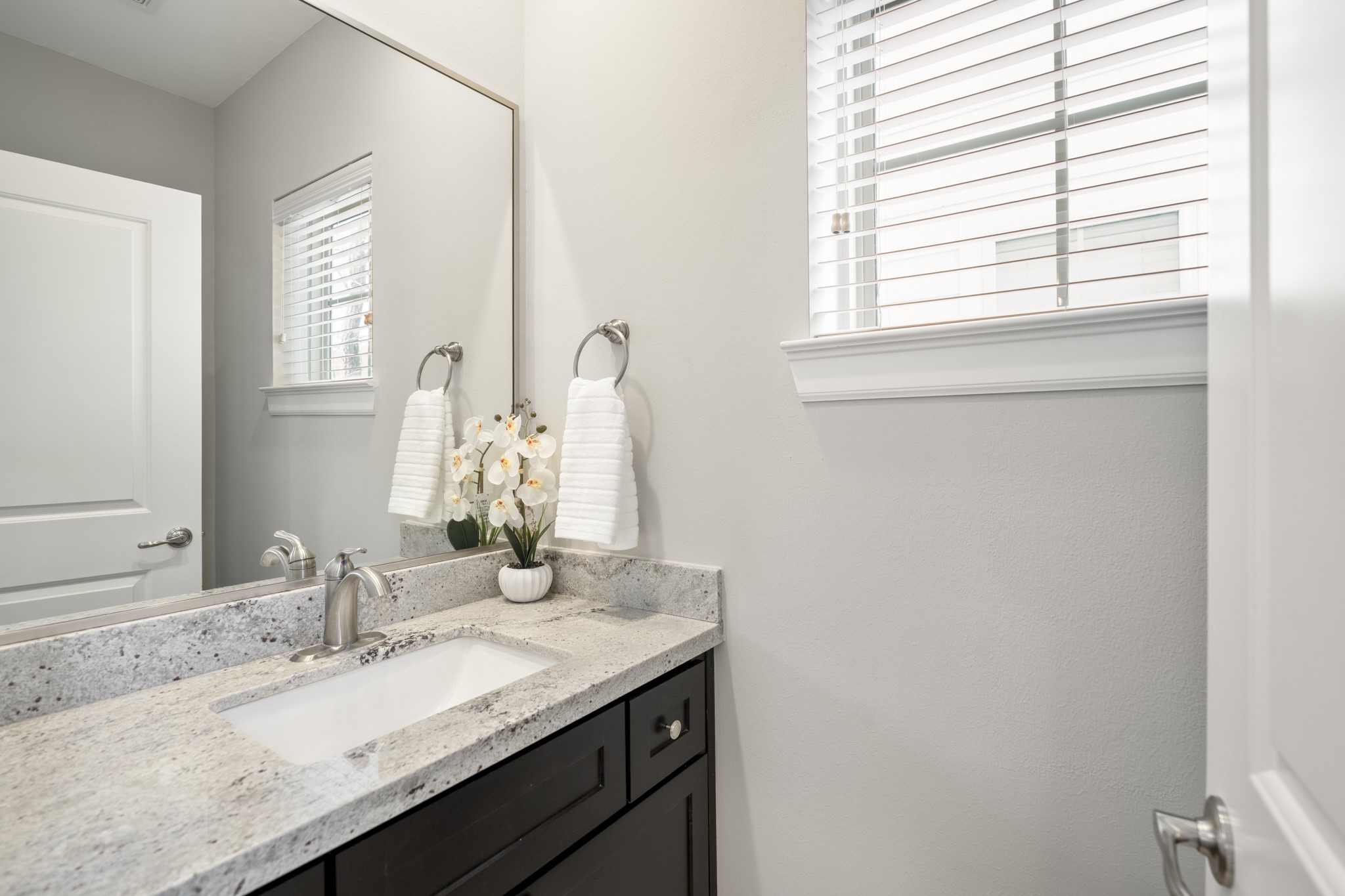 1032 West 26th Street, Unit D Houston, TX 77008 - Photo 13 of 42 a bathroom with a granite countertop sink and a mirror