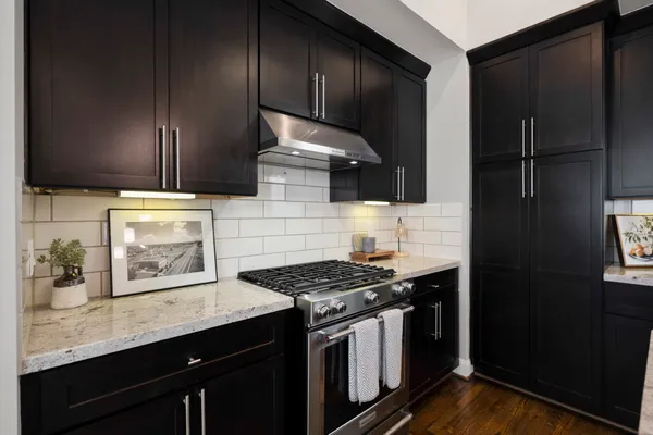 a kitchen with stainless steel appliances a sink stove and refrigerator