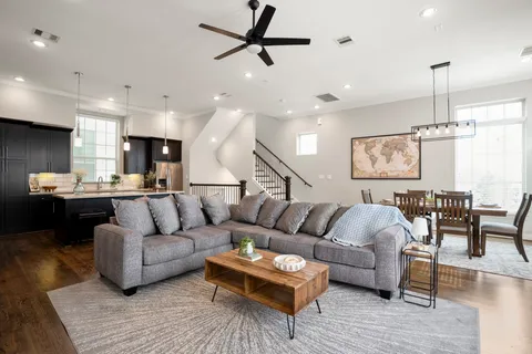 a living room with furniture and kitchen view
