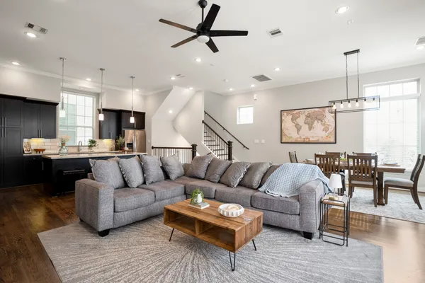 a living room with furniture and kitchen view