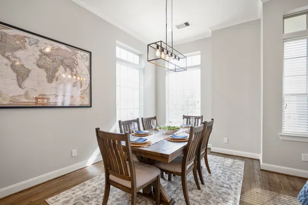 a view of a dining room with furniture window and wooden floor