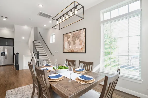 a view of a dining room with furniture window and wooden floor
