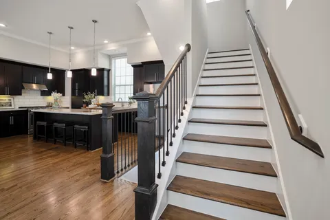 a view of entryway and hall with wooden floor
