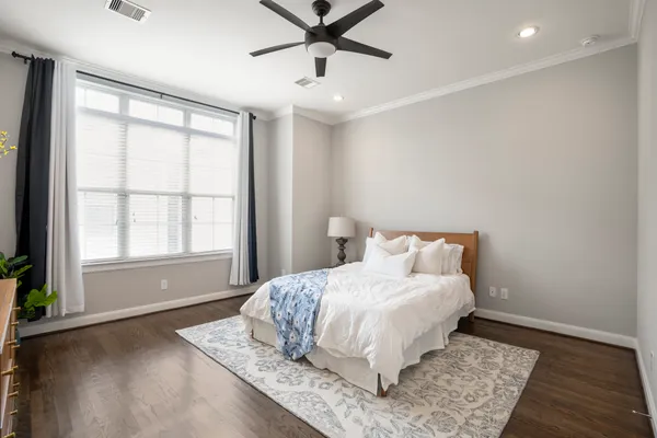 a bedroom with a large bed and a window