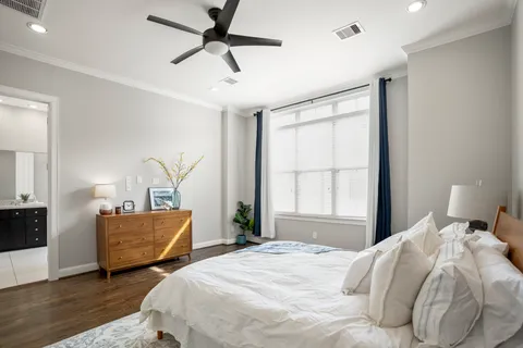 a bedroom with two beds and a large window