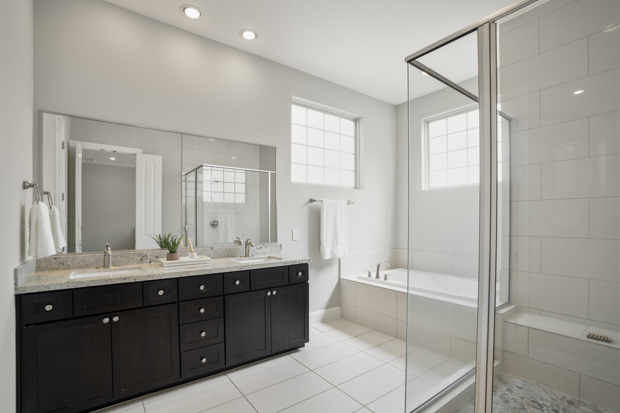 1032 West 26th Street, Unit D Houston, TX 77008 - Photo 36 of 42 a bathroom with a double vanity sink mirror double and shower