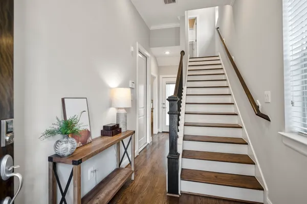 a view of entryway and hall with wooden floor