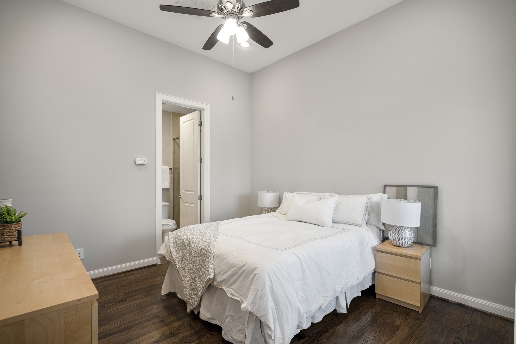 1032 West 26th Street, Unit D Houston, TX 77008 - Photo 8 of 42 a bedroom with a bed and wooden floor