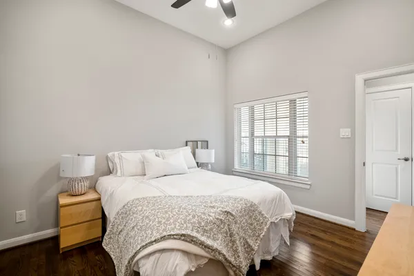 a bedroom with a bed and wooden floor