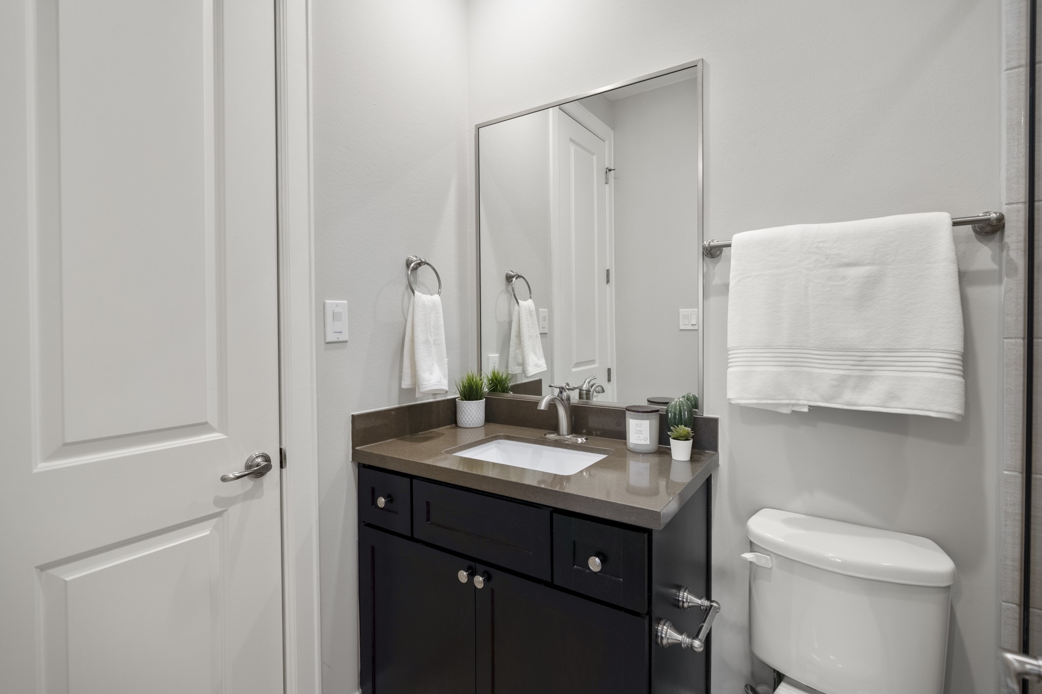 1032 West 26th Street, Unit D Houston, TX 77008 - Photo 10 of 42 a bathroom with a granite countertop sink toilet and mirror
