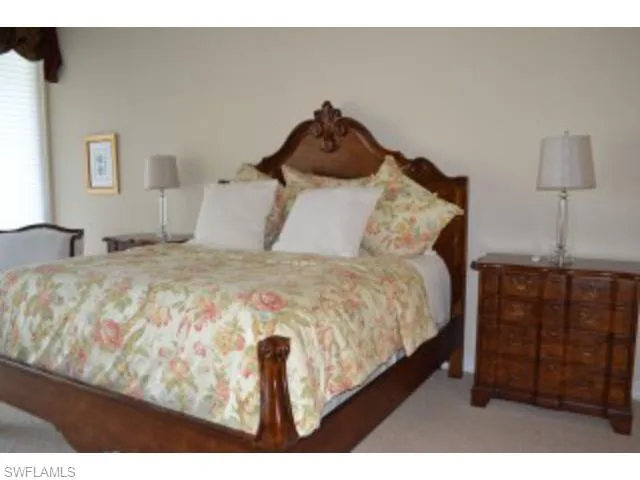 a bedroom with a bed and a television