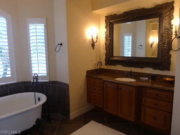 a bedroom with a bed and a mirror