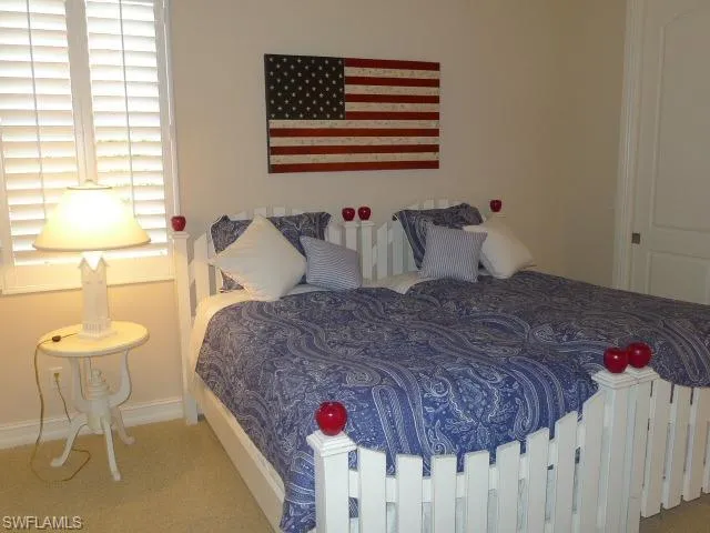 a bedroom with a fireplace and a flat screen tv