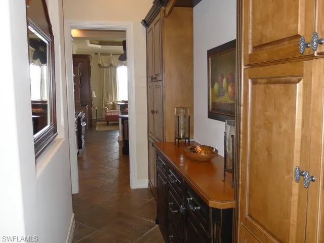 a view of a patio with table and chairs potted plants and palm tree