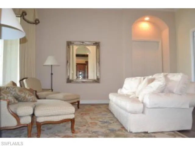 a living room with furniture and a lamp