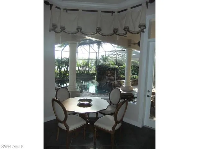 a view of a dining room with furniture and window