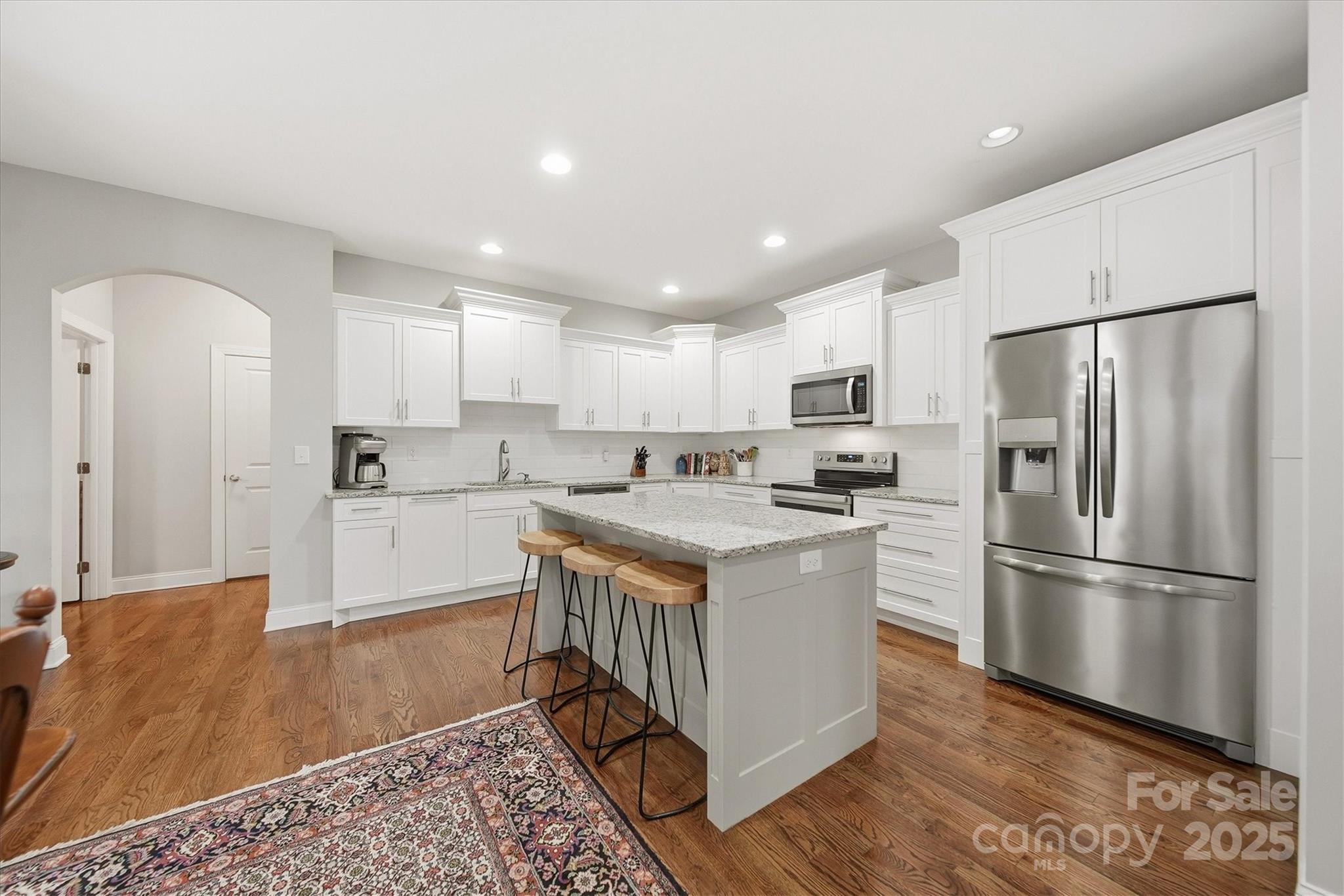 1449 North Center Street Hickory, NC 28601 - Photo 12 of 34 a kitchen with a refrigerator a sink and cabinets