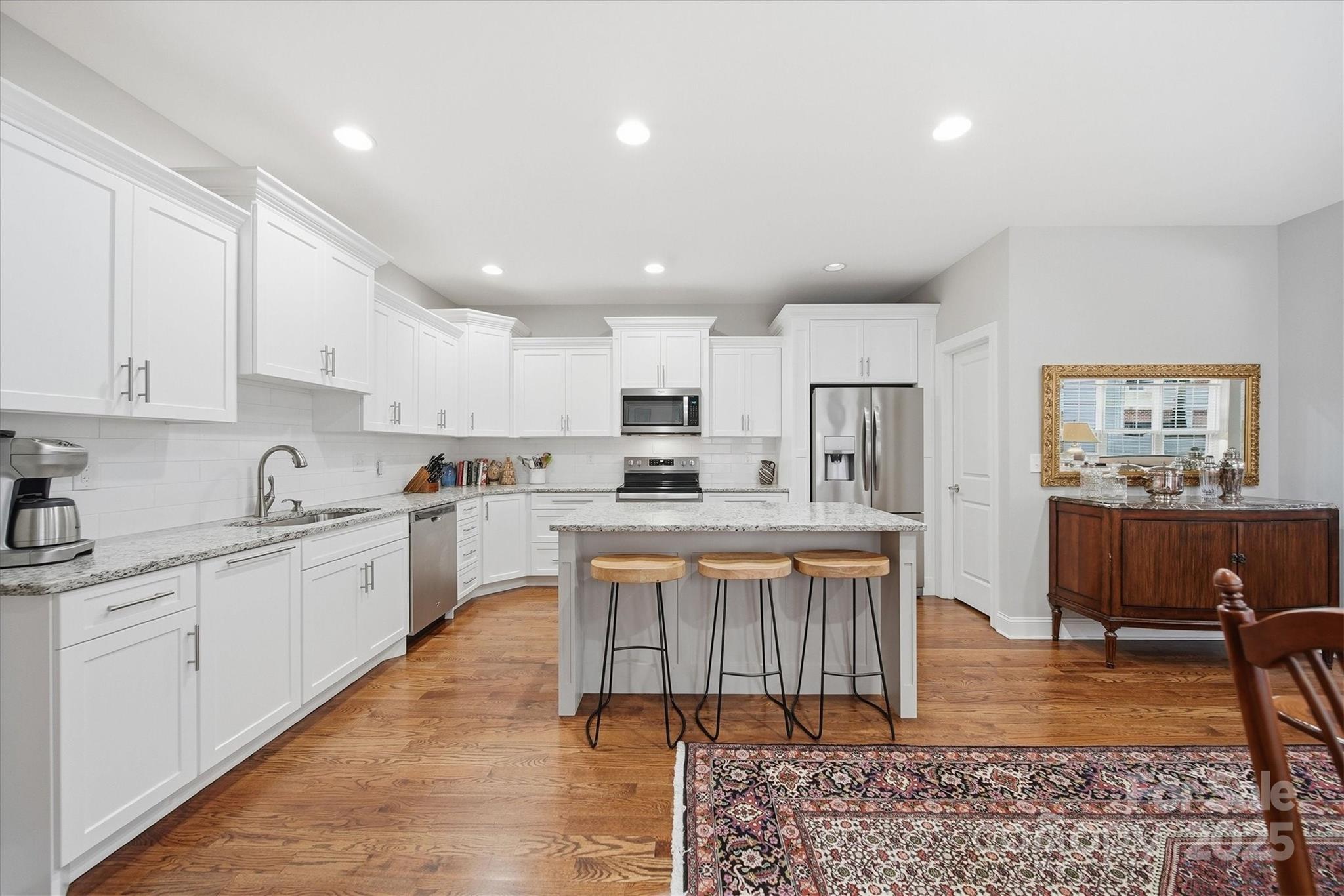 1449 North Center Street Hickory, NC 28601 - Photo 13 of 34 a large kitchen with kitchen island a sink a center island stainless steel appliances and a cabinets