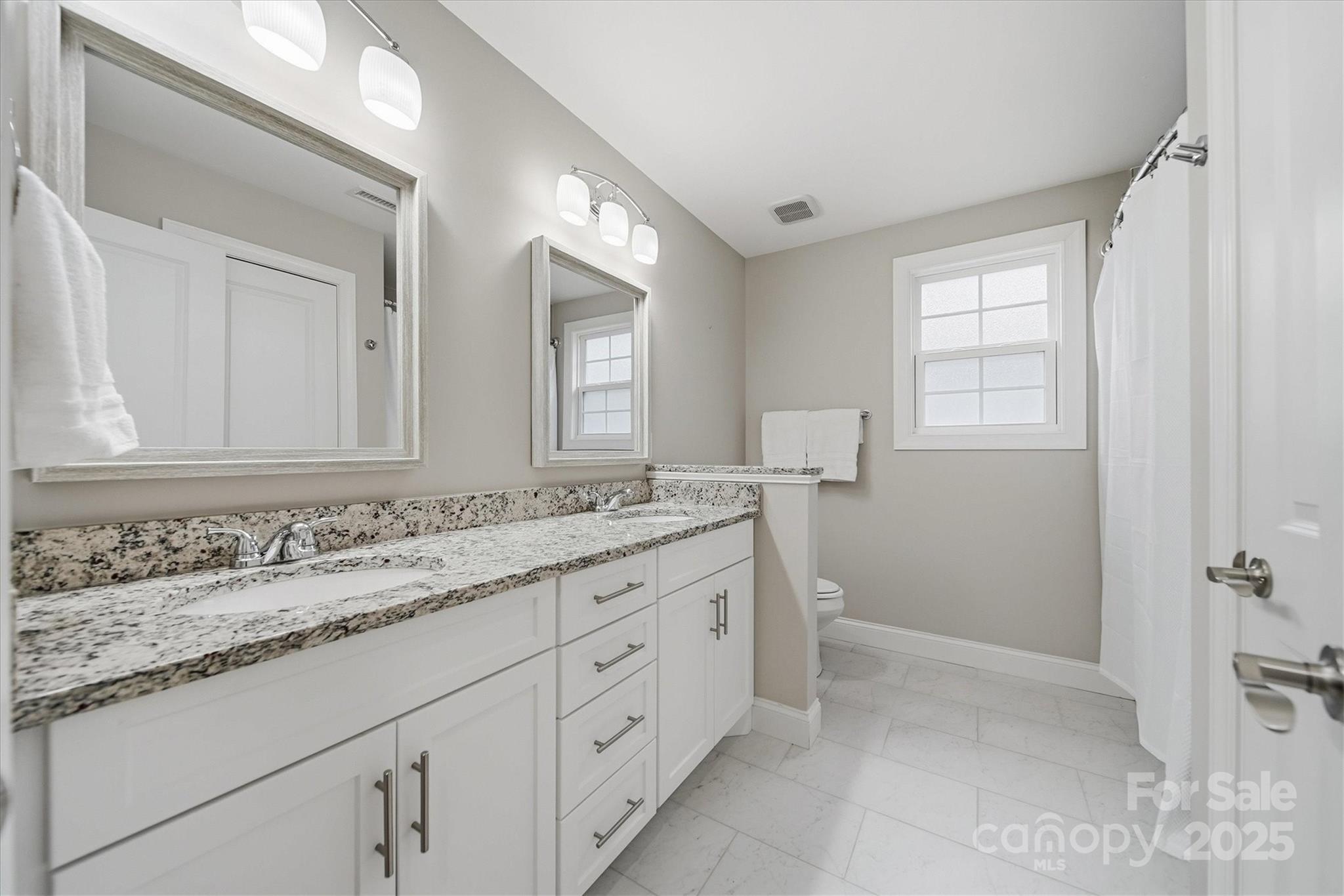1449 North Center Street Hickory, NC 28601 - Photo 23 of 34 a bathroom with a granite countertop sink mirror and a